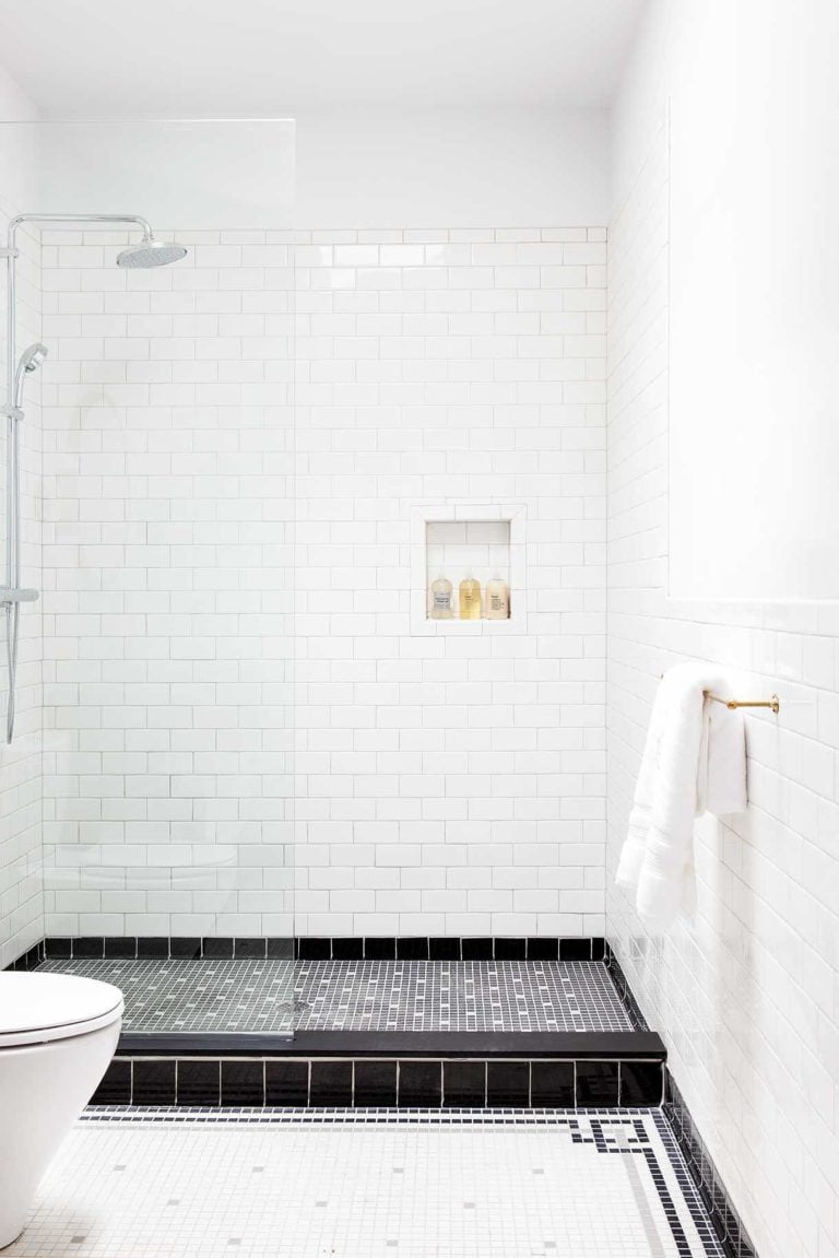 Boutique hotel shower with vintage black and white tile