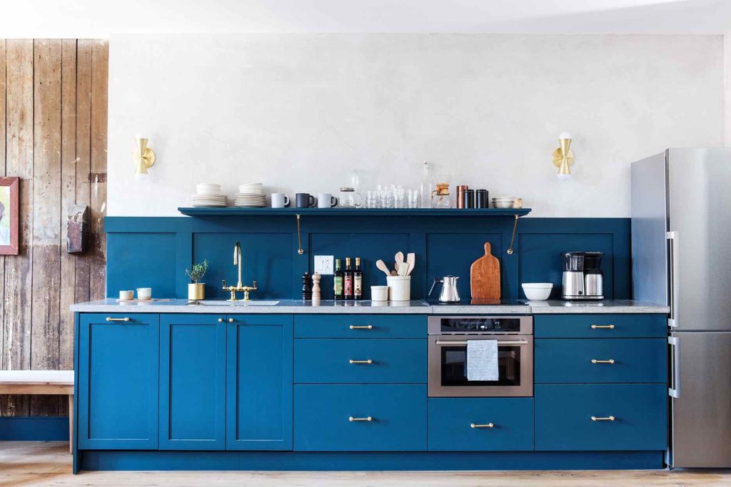 blue and brass kitchen with coffee makers apartment refrigerator and built in combi oven