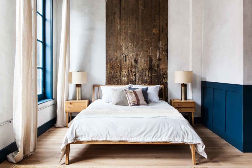 queen bed with antique reclaimed wood headboard and side tables from west elm