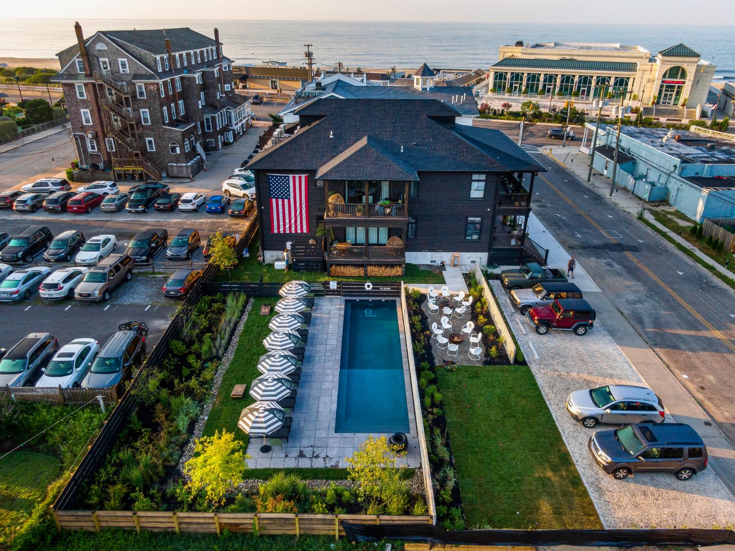 Lokal Hotel in Cape May from above with landscaped pool at bottom and ocean in background